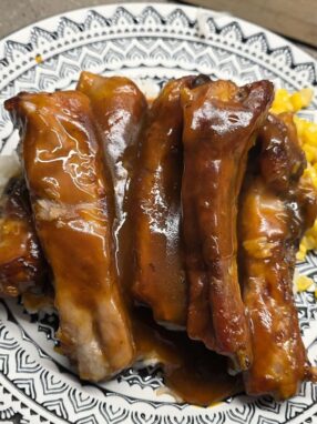 Close-up of tender sweet and sour ribs coated in thick sticky glaze
