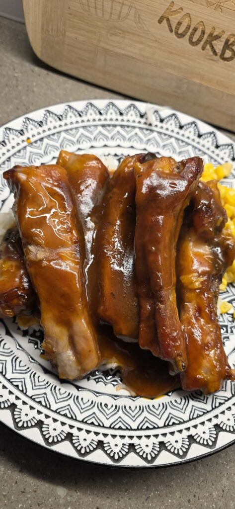 Close-up of tender sweet and sour ribs coated in thick sticky glaze